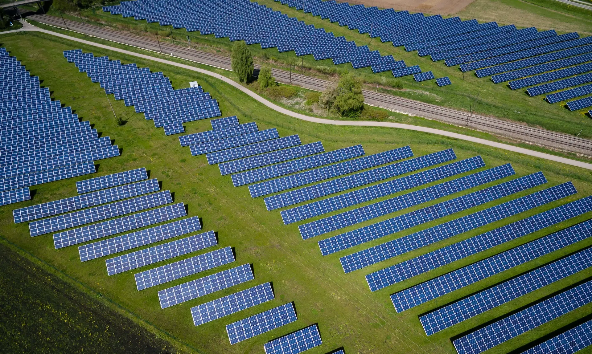 aerial photography of grass field with blue solar panels